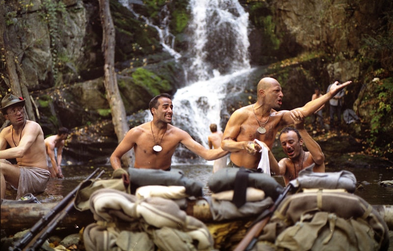 Italian soldiers bathing and laughing at a waterfall